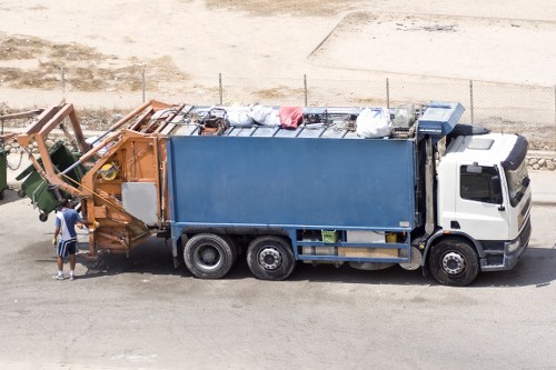 Company van at a commercial waste site showing insured service branding