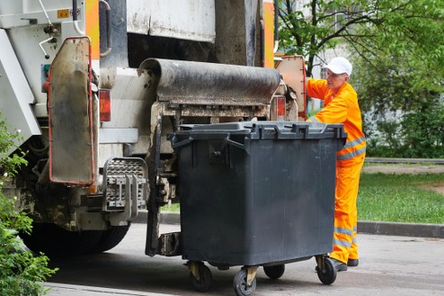 Team performing safe vehicle loading for commercial waste transport